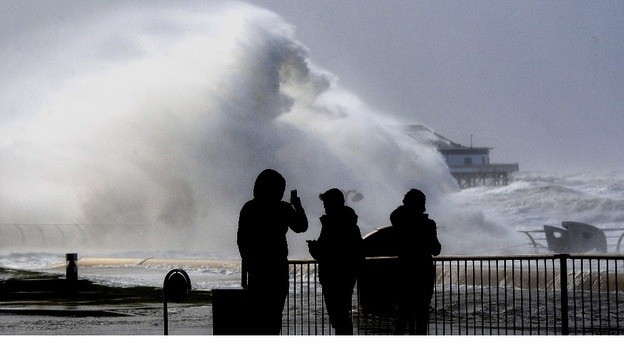 People take pictures on the Blackpool Main Promenade.
