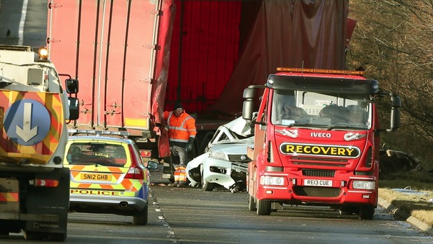 Police and recovery vehicles at the scene where a lorry driver has died as his HGV toppled on to a number of cars on the A801.