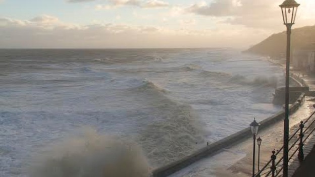 The stormy sea engulfs the coast.