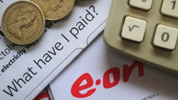 General view of an E.ON energy bill and some pound coins.