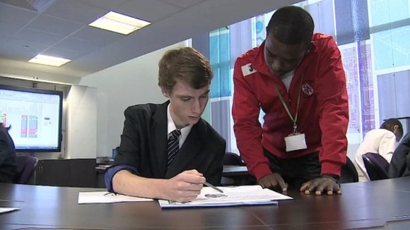 Eddie Odhiambo watches over a pupil's work.