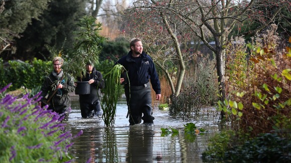 Head Gardener Steve Edney wades through flood water as he rescues rare plants with his team from the Secret Gardens of Sandwich.