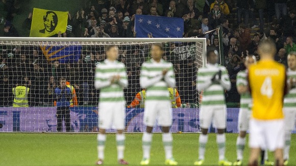 Fans hold up a banner in memory of Nelson Mandela during a minutes applause before the Scottish Premiership match at Fir Park.