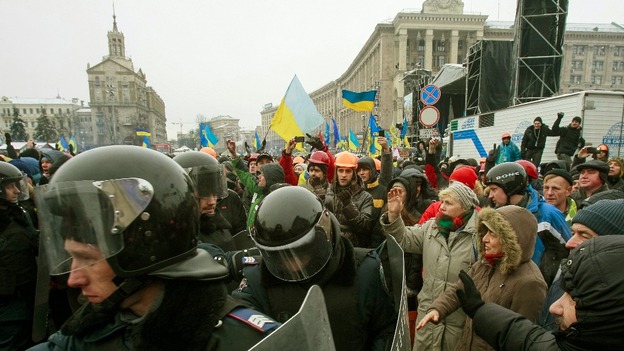 Riot police leave Independence Square in Kiev.
