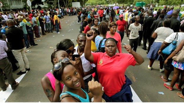 A group of friends dance in the queue to view Nelson Mandela's body.