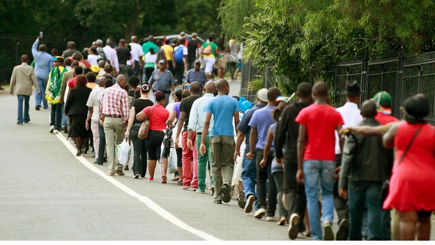People queue to view the body of former South African President Nelson Mandela.