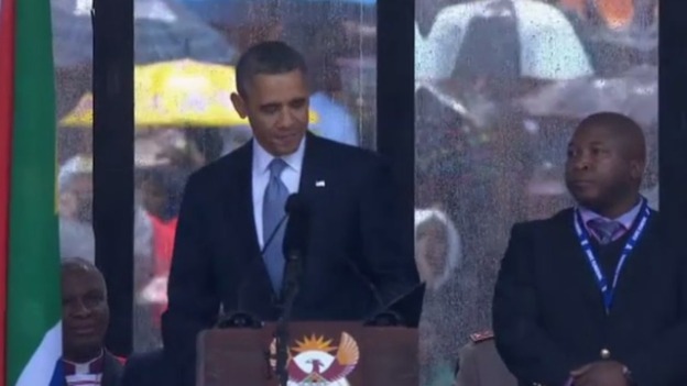The mystery man stood within feet of President Obama as he gave his address at the memorial.
