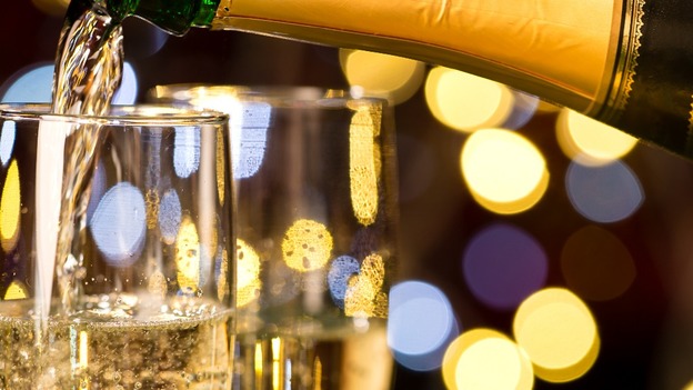 Glasses of champagne and present for special occasion gold decoration.