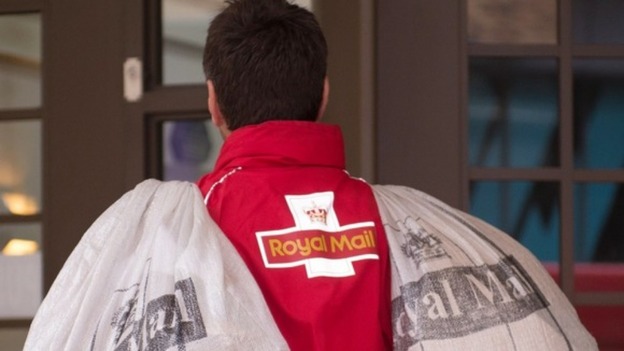 a Royal Mail worker carrying two mail sacks.