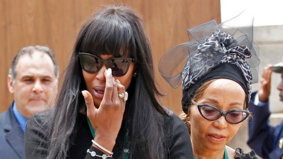Supermodel Naomi Campbell reacts after viewing the coffin of Mandela.