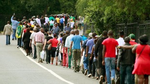 People queue to view the body of former South African President Nelson Mandela.