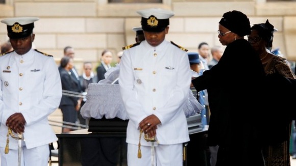 Graca Machel, Nelson Mandela's widow, visits his coffin in Pretoria.
