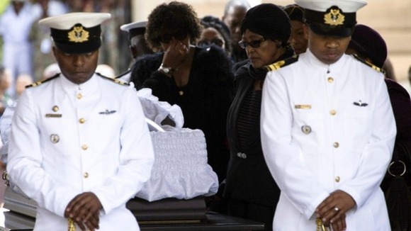 Nelson Mandela's ex-wife Winnie pays her respects at his coffin.