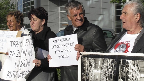Munira Subasic, right, takes part in a small demonstration of relatives of the Bosnian war dead outside the court in The Hague.