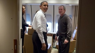 President Barack Obama jokes with former President George W. Bush shortly after boarding Air Force One for the trip to South Africa.