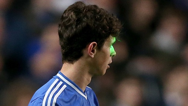A laser beam is shone in the face of Chelsea's Oscar