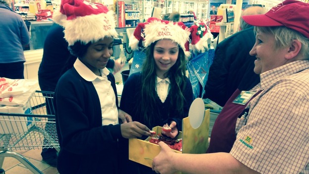 Children help pack bags for the Text Santa appeal