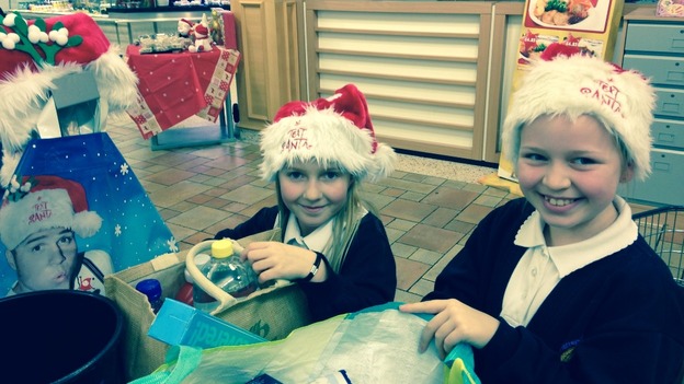 Children help pack bags for the Text Santa appeal