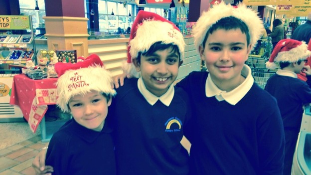 Children help pack bags for the Text Santa appeal