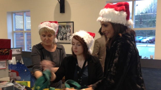 The presenter helps youngsters in the charity bag pack
