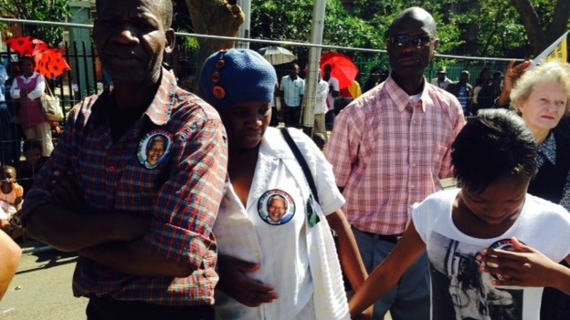 South Africans wear stickers with Nelson Mandela's face with pride