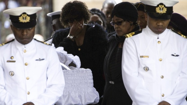 Winnie Mandela pays her respects at Nelson Mandela's coffin as he lies in state at the Union Buildings in Pretoria.