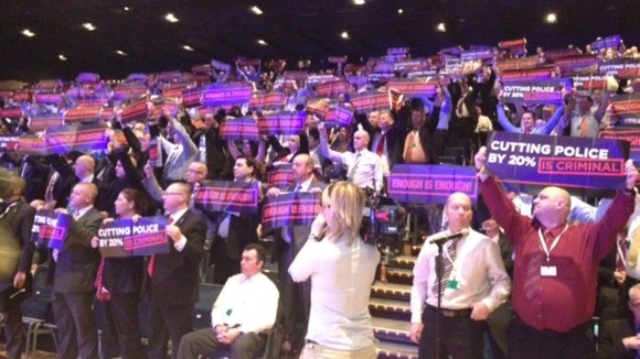 Police at police federation conference hold up signs saying "Enough is enough".