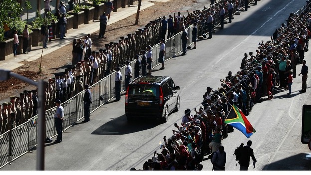 Mourners line along the street as the funeral cortege drives to the Union Buildings in Pretoria.