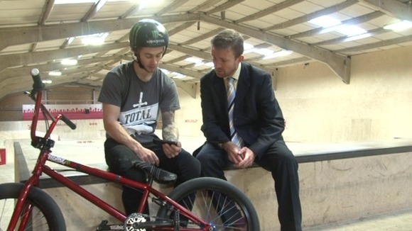 Alex Coleborn watches one of his YouTube clips with ITV News Anglia's Russell Hookey.