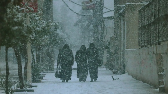 Damascus residents in a rare snowstorm