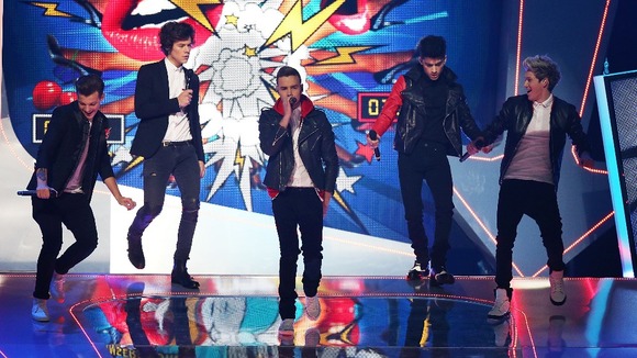 Louis Tomlinson, Harry Styles, Liam Payne, Zayn Malik and Niall Horan of One Direction perform during the 2013 Brit Awards.