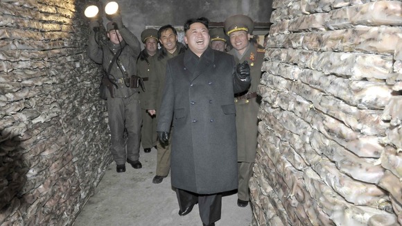 Kim Jong-un poses for pictures among the frozen squid.