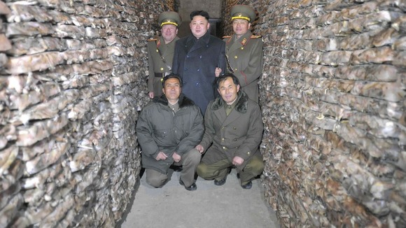 Kim Jong-un poses for pictures among the frozen squid.