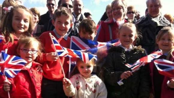 Children prepare to welcome the royals in Burnley