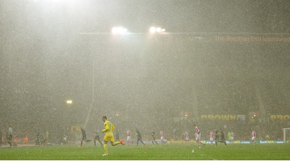 Players leave the pitch due to the hail during the Capital One Cup match