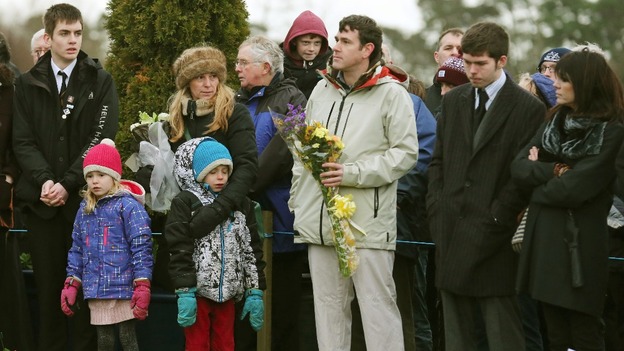 Relatives prepare to lay flowers during the memorial service