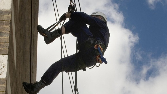 Metropolitan Police officers practise abseiling techniques at their River Thames base in Wapping