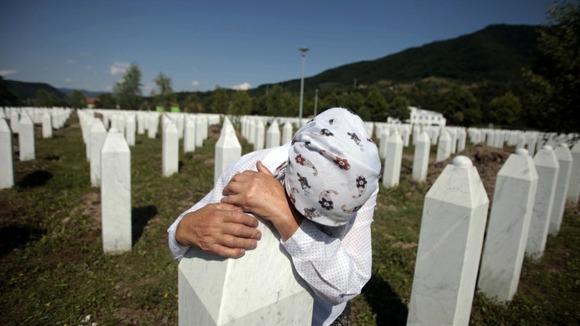 Adila Suljakovic cries at the grave of her son in the Memorial Center in Potocari, near Srebrenica.