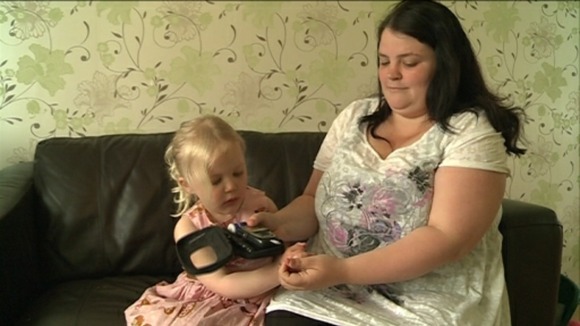 Jodie Steed testing her daughter Olivia's blood sugar levels 