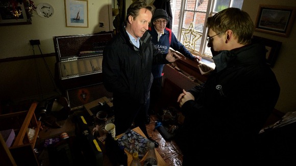 David Cameron visits a flood-affected resident in Yalding, Kent