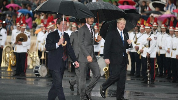 David Beckham (centre) and Mayor of London Boris Johnson (right) during the official handover ceremony of the Olympic Flame