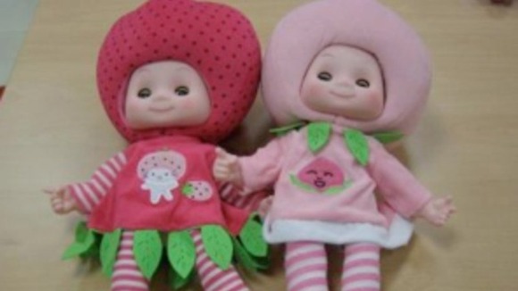 A strawberry and a raspberry 'fruit-head' doll
