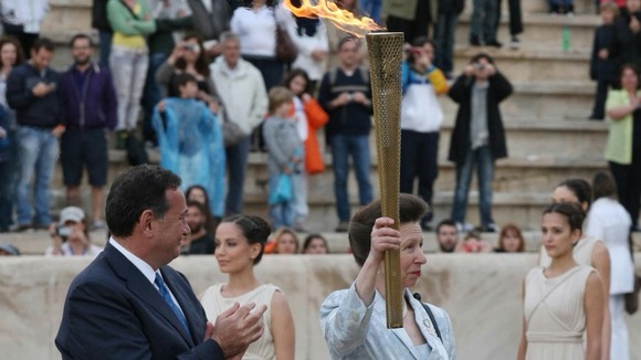 The Princess Royal is presented with the torch during the official handover ceremony at the Panathenaic Stadium.