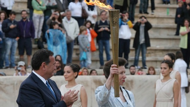 The Princess Royal is presented with the torch during the official handover ceremony at the Panathenaic Stadium.