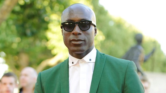Fashion designer Ozwald Boateng in a bright green suit.
