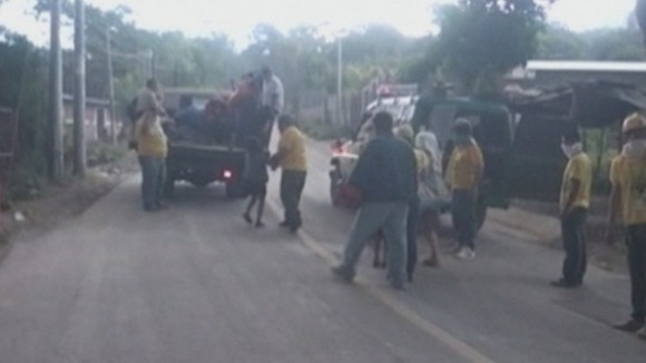 Rescue workers helping residents get onto truck so they can evacuate the area.