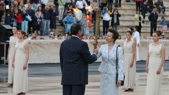 The Princess Royal is handed the torch during the ceremony.