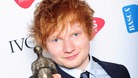 Ed Sheeran shows off his prize at London's Grosvenor House Hotel.