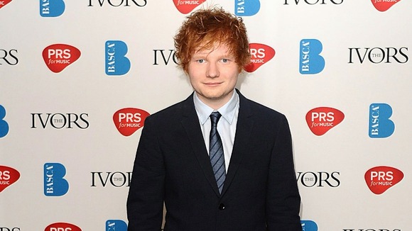 Ed Sheeran celebrates an Ivor Novello award.