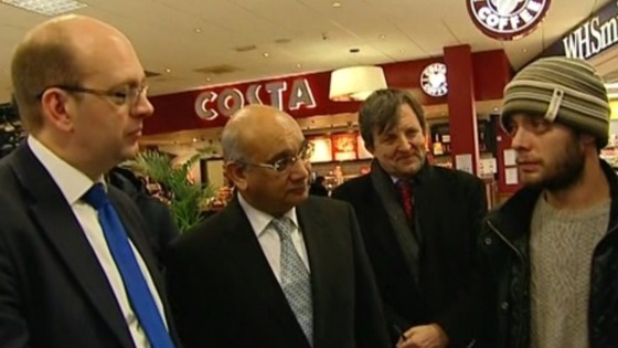 Keith Vaz MP (second from L) greets a Romanian passenger at Luton Airport